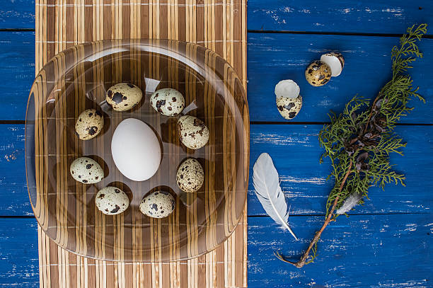 istock Chicken and quail eggs on a dark transparent plate. Top 635932606