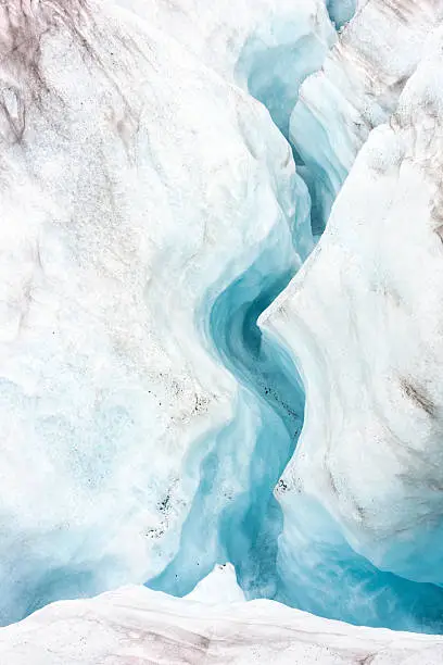 Glacier water rushing through crevasses in blue ice creating a moulin under the surface of Lemon Glacier, Juneau Icefield, Juneau, Alaska, USA