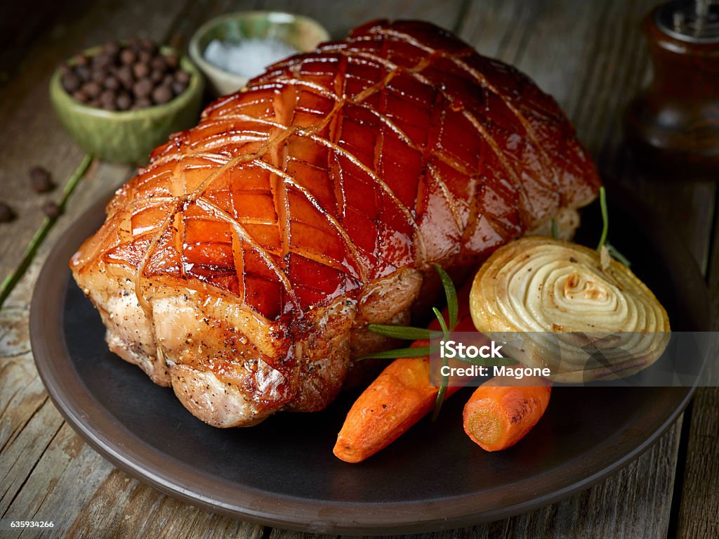 roasted pork on dark plate roasted pork and vegetables on dark plate Ham Stock Photo