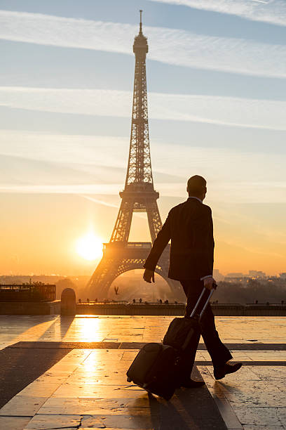 istock Travel businessman walking with suitcase at Eiffel Tower in Paris 635938496