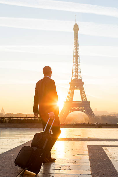 istock Travel businessman walking with suitcase at Eiffel Tower in Paris 635938518