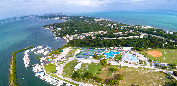 Aerial Drone View of the Waterfront Inlet in Downtown West Palm Beach, Florida & Palm Beach at Midday in June 2022