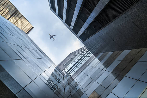 istock modern skyscraper and flying plane,Hong Kong 635939654