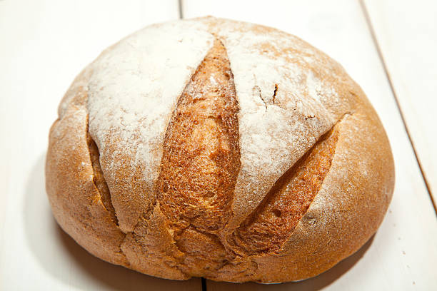 istock Bread on a white wooden background 635940416