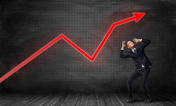istock Businessman standing on floorboard and bending in fear under bright 635940920