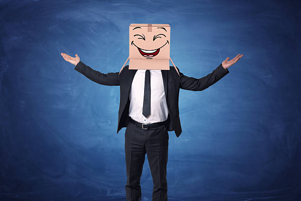 istock Businessman raising hands up and wearing box on his head 635940954