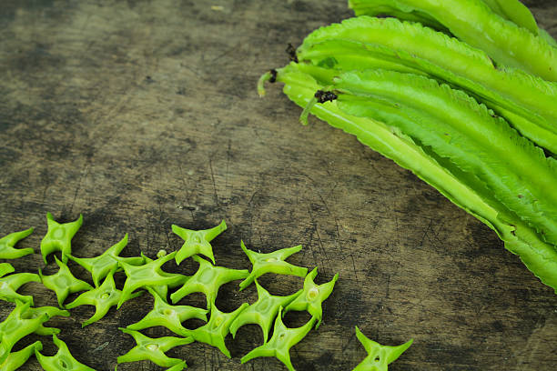 winged beans on wooden background, princess bean - sophocles imagens e fotografias de stock