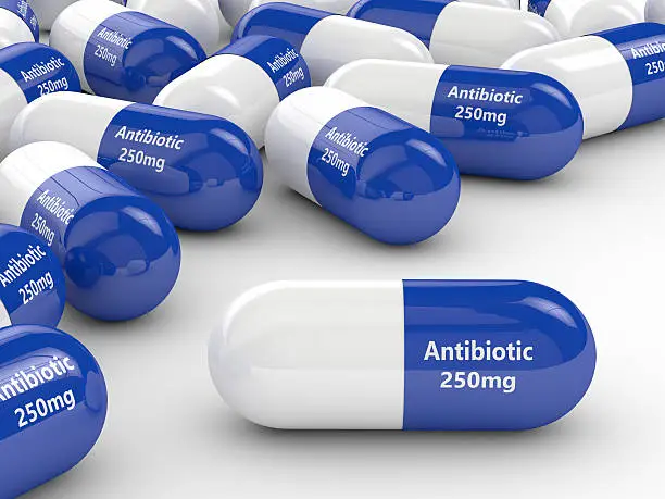 Photo of 3d rendering of antibiotic pills over white