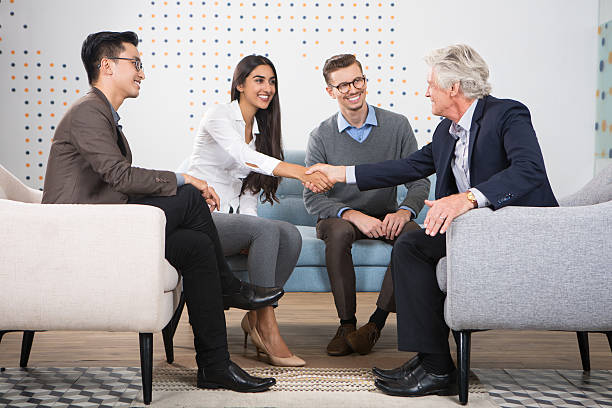 istock Young and Senior Business People Shaking Hands 635949418