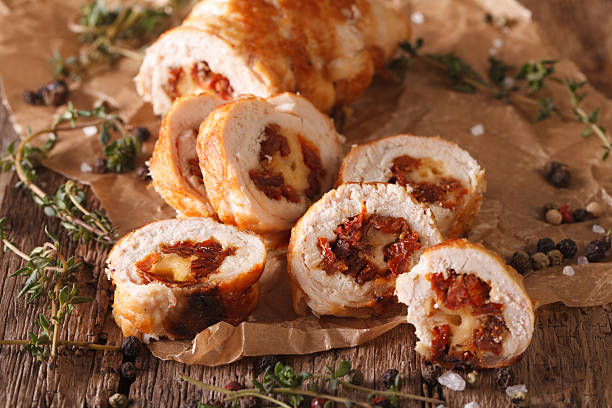 istock Chicken roll stuffed with cheese and sun-dried tomatoes close-up 635950064