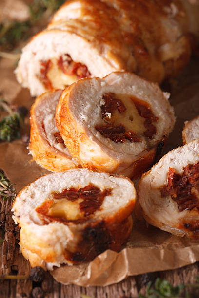 istock Chicken roll stuffed with cheese and sun-dried tomatoes close-up 635950142