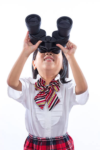 istock Asian Chinese little girl looking through binoculars 635950778