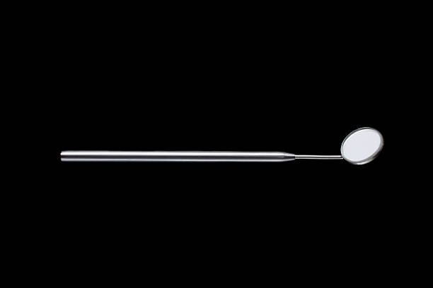 istock Closeup of dental mirror on black background 635952826