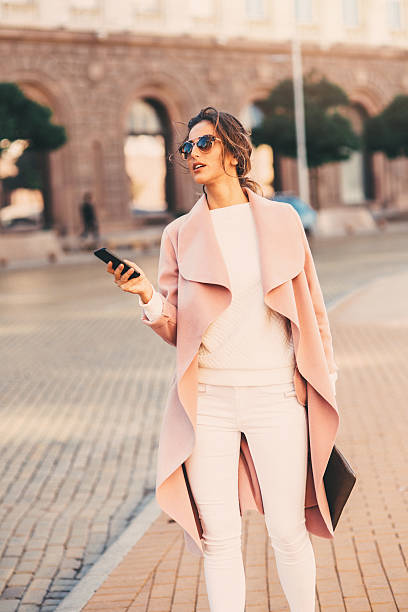 istock Beautiful woman texting on the phone 635954252