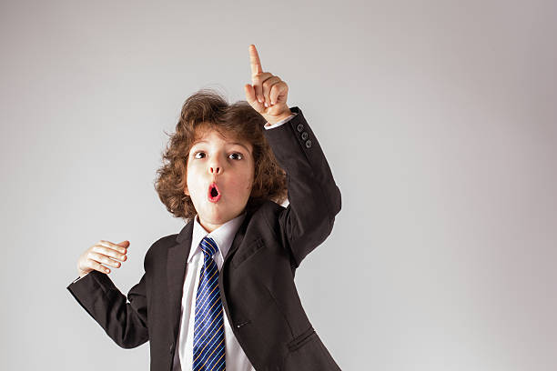 istock Funny curly boy gesturing with his mouth open. Gray background. 635956722