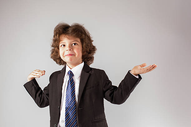 istock Funny curly boy gesturing and looking up. Gray background. 635956876