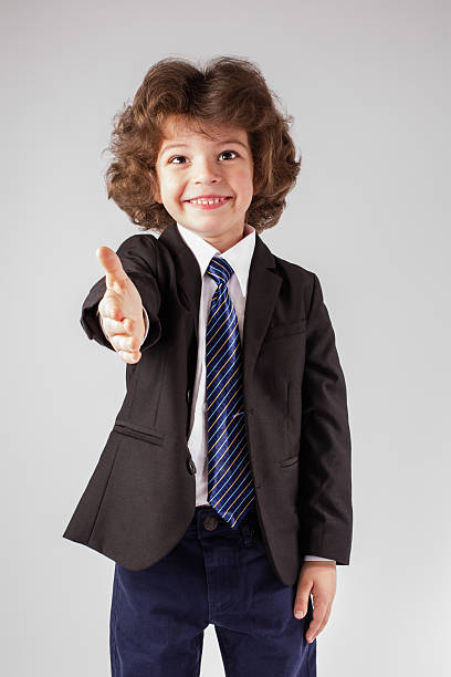 istock Curly happy boy holds out his hand in greeting. 635957100