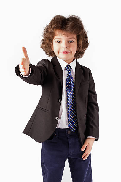 istock Curly happy boy holds out his hand in greeting camera. 635957470