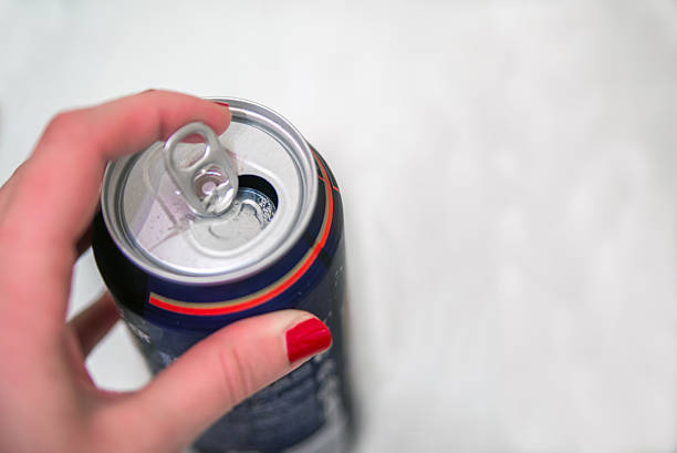 istock Hands opening a soda (beer) can. Opening aluminum beer can 635958048