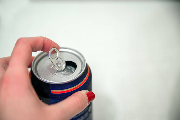 istock Hands opening a soda (beer) can. Close up 635958252