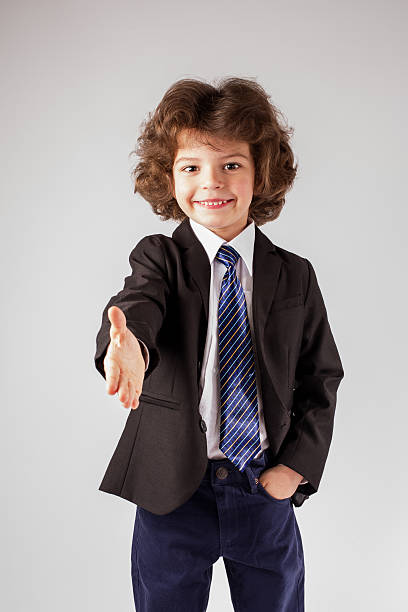 istock Curly boy boy casually holds out his hand in greeting. 635958638