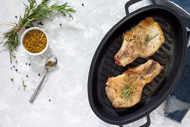 istock Pork on the bone in a cast-iron barbecue pan 635958656