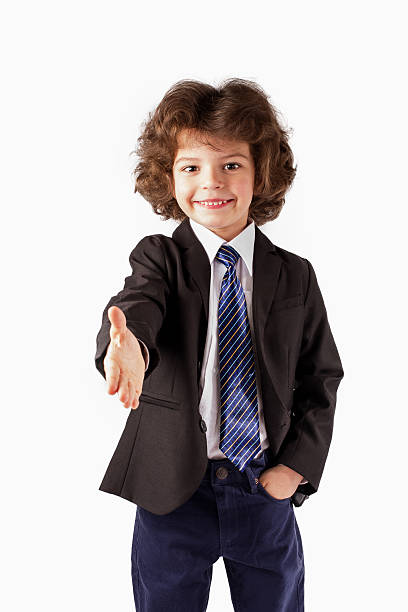 istock Curly boy boy casually holds out his hand in greeting. 635958764