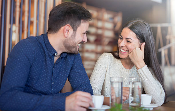 pareja amorosa romántica teniendo una cita en el café - whispering couple discussion smiling fotografías e imágenes de stock