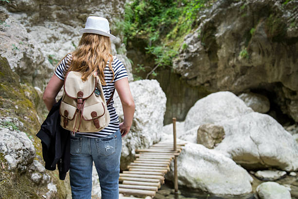 istock Young hipster woman crossing a bridge 635962864