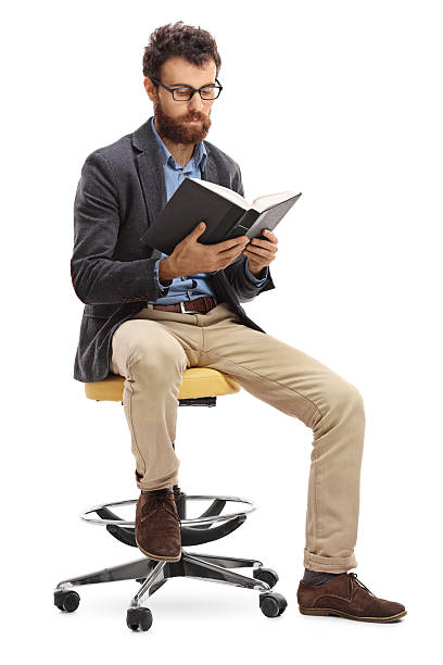 istock Man sitting on a chair and reading a book 635963460
