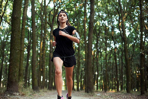 istock Female jogging in park 635966122