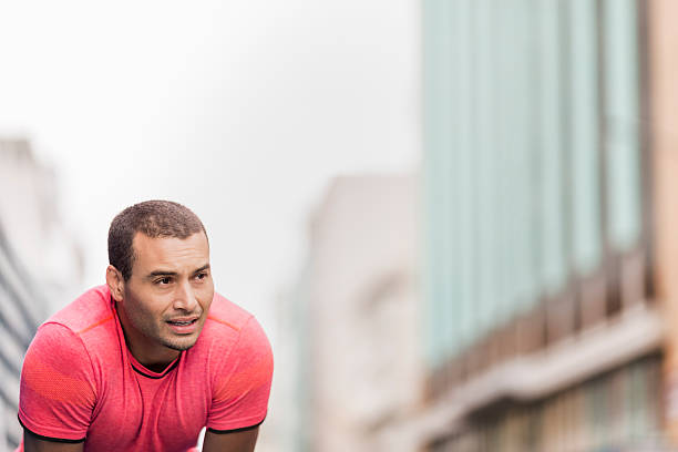 istock Thoughtful male athlete bending in city 635966718