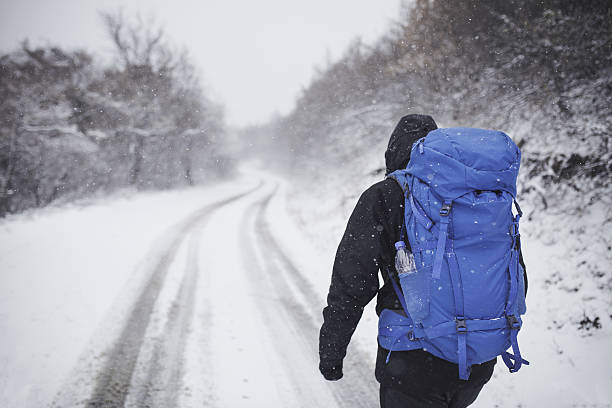istock Man hiker hiking in white winter. 635970098