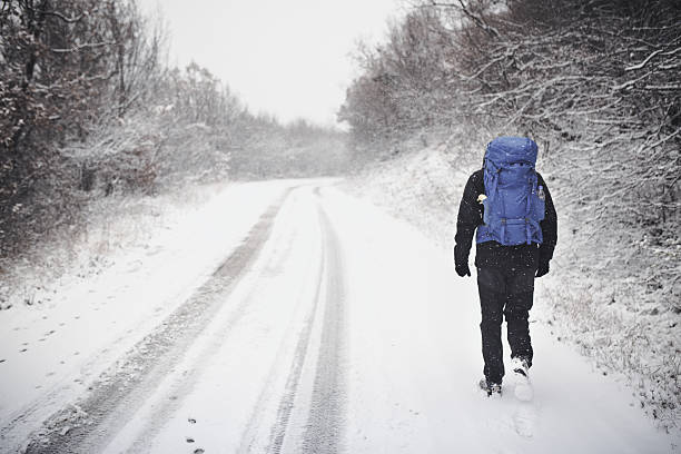 istock Man hiker hiking in white winter. 635970222