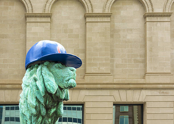 Chicago, United States - October 27, 2016: Chicago Art Institute entrance lion sculpture with Chicago Cubs hat supporting the club for the baseball world series
