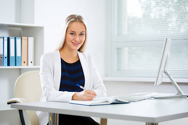 istock Young business woman with computer 635971222