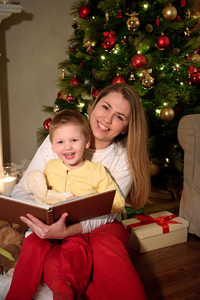 istock boy and his mom reading a book together laughing 635971944