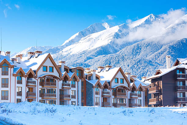Houses and snow mountains panorama in bulgarian ski resort Bansko Wooden chalet, houses and snow mountains landscape panorama in bulgarian ski resort Bansko, Bulgaria bulgaria stock pictures, royalty-free photos & images
