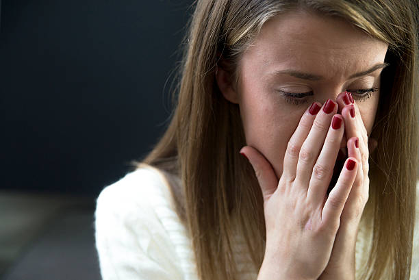 istock stressed young woman touching head and thinking 635973826