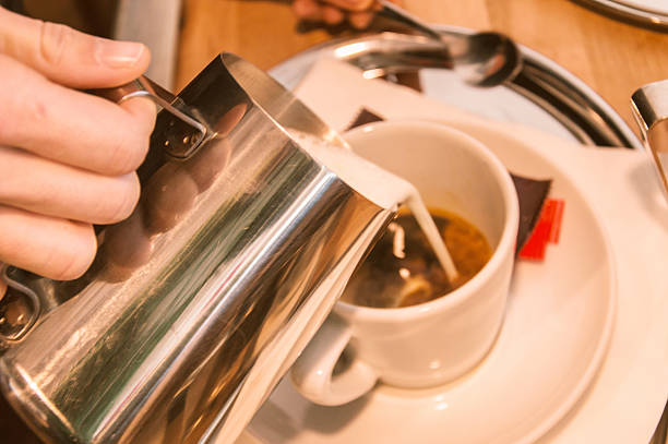 istock Young barista is making a coffee - Stock image 635974330