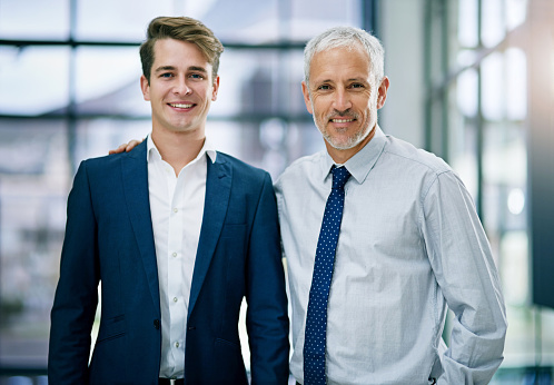 Portrait of two businessmen standing together in an office