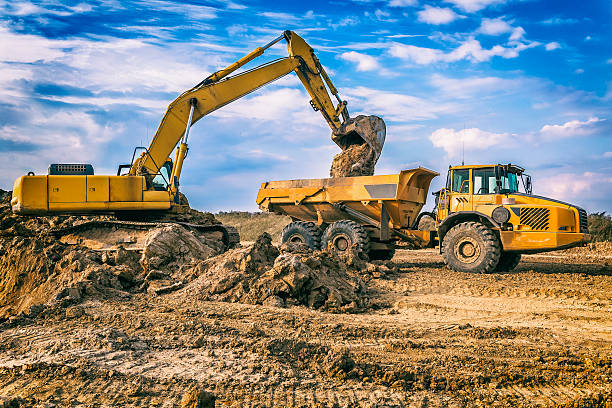 istock Excavator and dump truck in highway construction S3, Poland 635982568