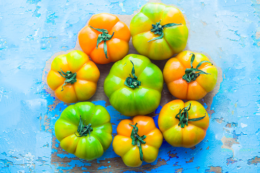 Close up of heirloom tomatoes over a blu rusty background