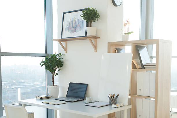 istock Side view picture of studio workplace with blank notebook, laptop 635986738