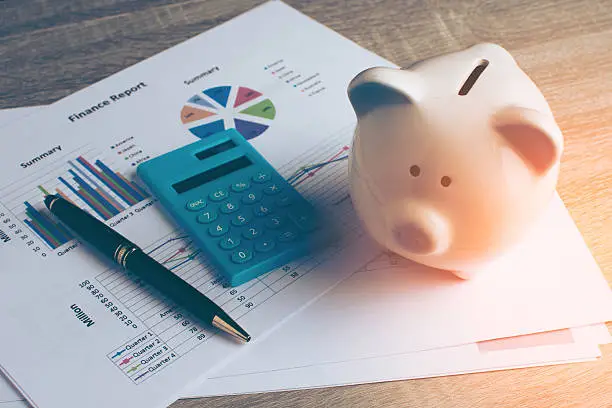 Photo of Piggy bank with business stuff.