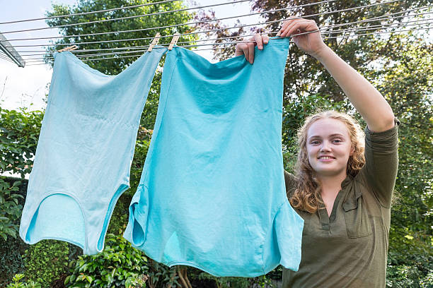 Young dutch woman hanging laundry at clothesline stock photo
