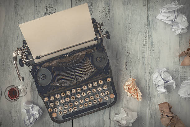 istock Typewriter with blank sheet of paper 635987954