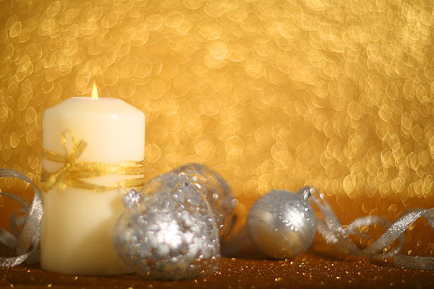 istock Christmas candle on shiny background 635989788