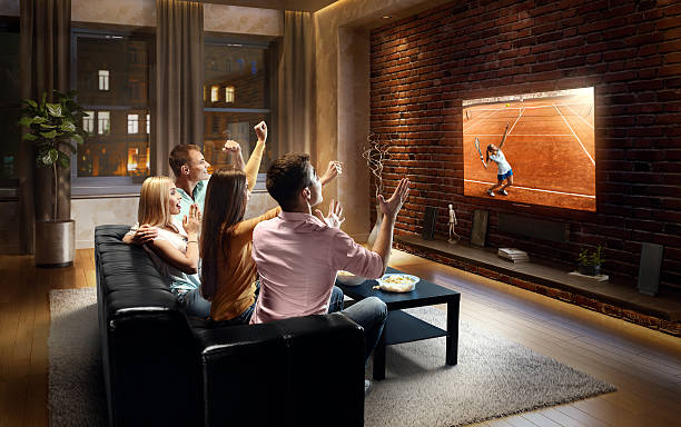 istock Couples watching Tennis game at home 635989854