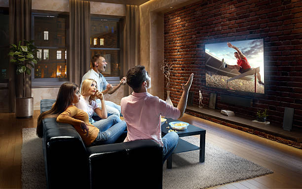 istock Couples watching very realistic Hurdling sport on TV 635990128